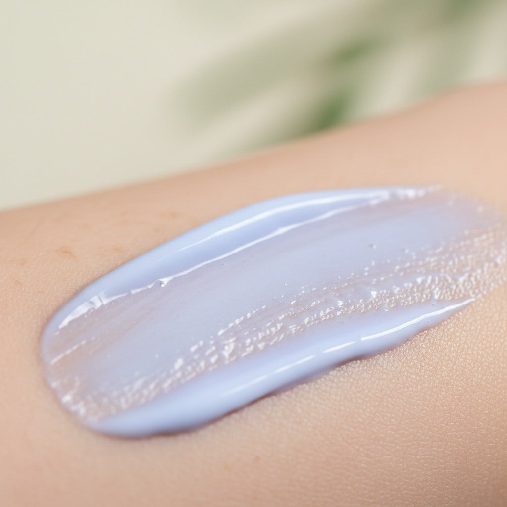 Pale periwinkle serum smoothed over soft, refined skin