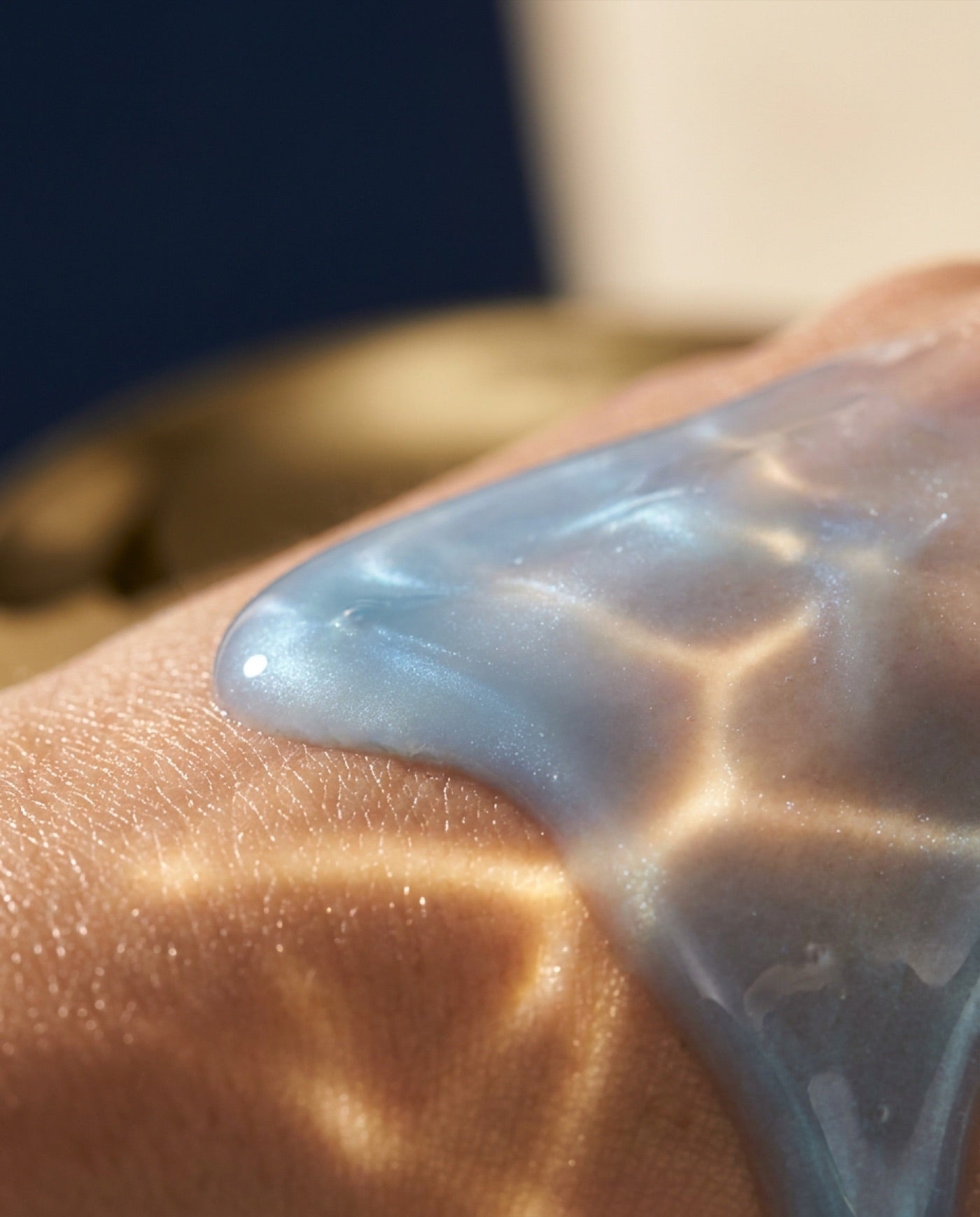 The pale-blue serum spread across skin